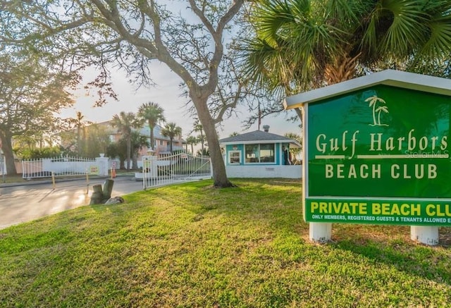 community / neighborhood sign with a lawn