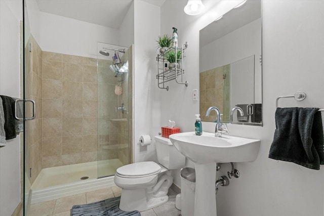 bathroom with walk in shower, tile flooring, and toilet