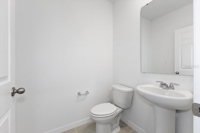 bathroom with tile patterned floors and toilet