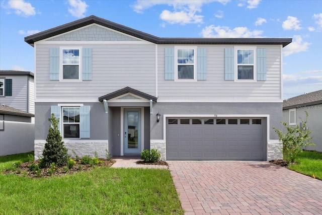 view of front of home with a garage and a front lawn