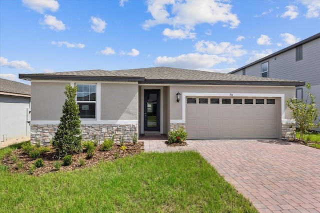 view of front of house with a garage and a front lawn