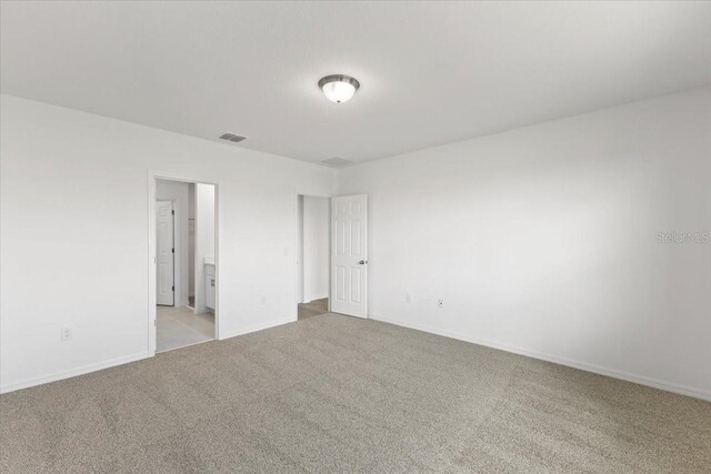 empty room with light colored carpet