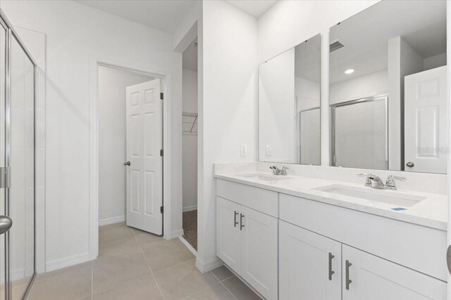 bathroom featuring an enclosed shower, vanity, and tile patterned floors