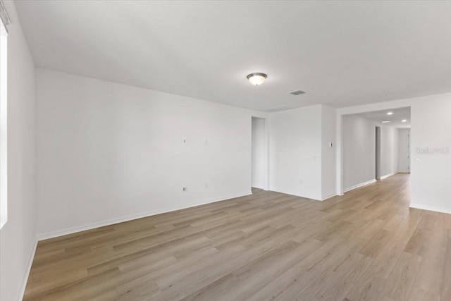 empty room with light hardwood / wood-style flooring