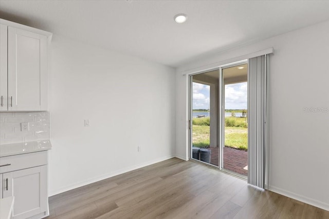 unfurnished dining area with light hardwood / wood-style flooring