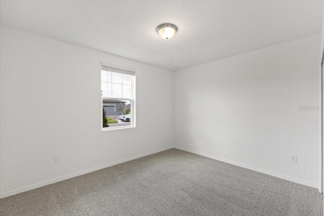 unfurnished room featuring carpet flooring