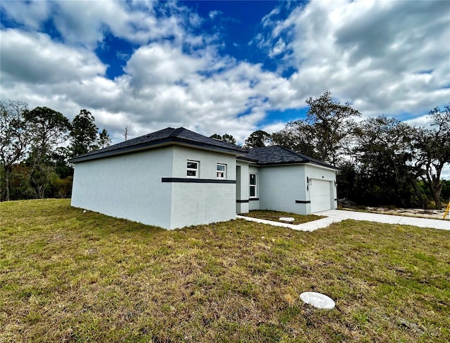 view of side of property featuring a yard and a garage