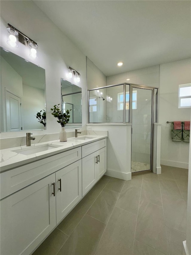 bathroom featuring a shower with shower door, tile patterned floors, and vanity