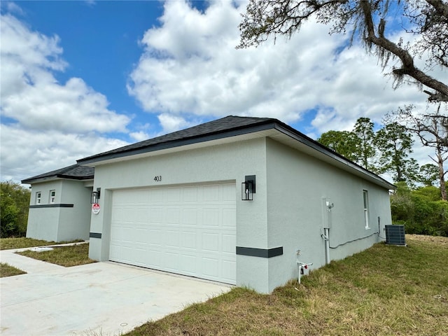 view of home's exterior with a yard, central AC unit, and a garage