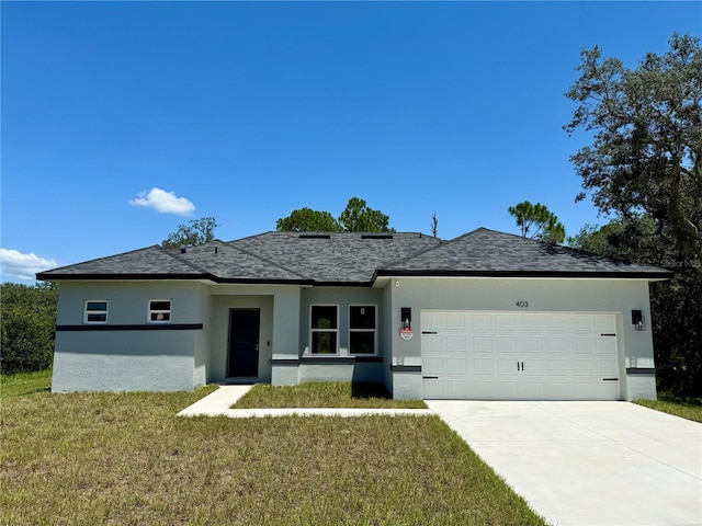 ranch-style house featuring a garage and a front lawn