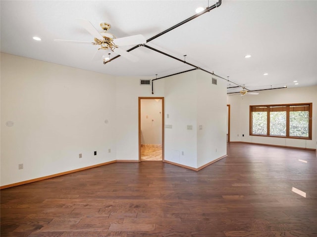 empty room featuring ceiling fan and dark hardwood / wood-style flooring