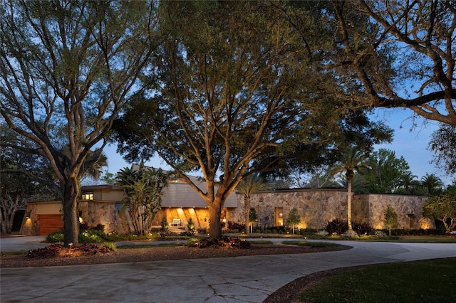 208 Green Lake Cir, Longwood, FL 32779 - view of front facade featuring curved driveway and stone siding