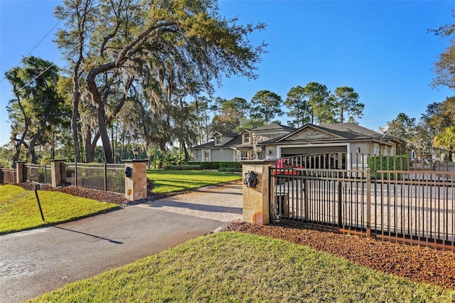 view of gate featuring a yard and a garage