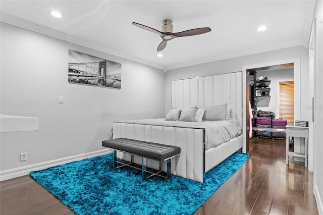 bedroom featuring hardwood / wood-style flooring, ceiling fan, and crown molding