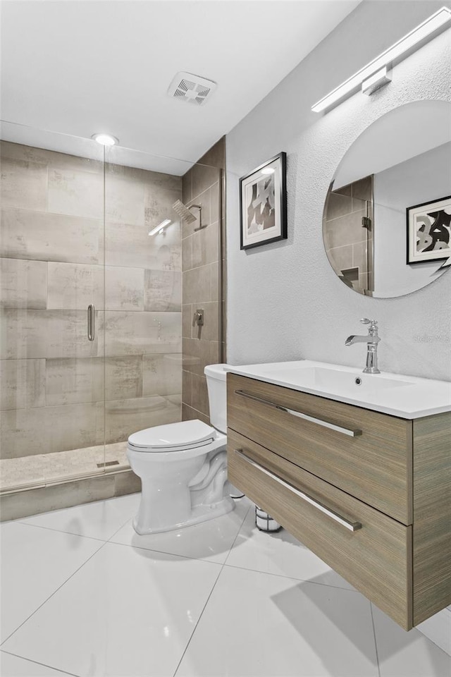 bathroom featuring walk in shower, vanity, toilet, and tile patterned flooring