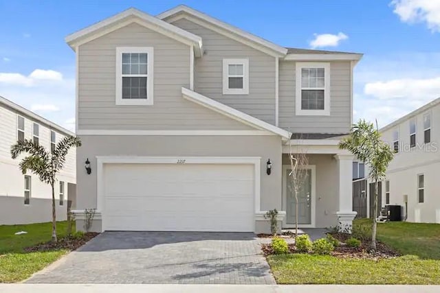 view of front of property featuring a front lawn and a garage