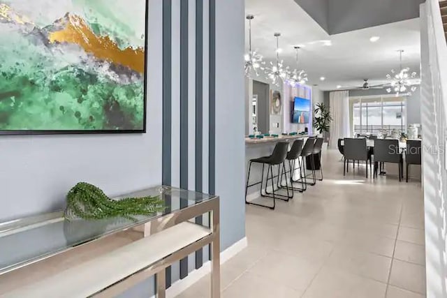 interior space with light tile floors and an inviting chandelier