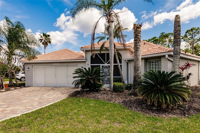 mediterranean / spanish-style house with a garage and a front yard