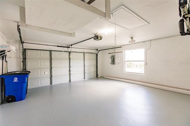 garage with a garage door opener and electric panel