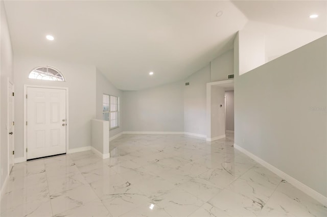 entrance foyer featuring high vaulted ceiling