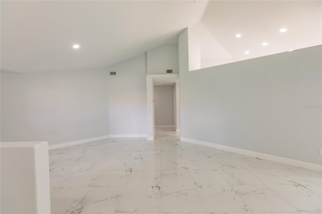 empty room featuring high vaulted ceiling