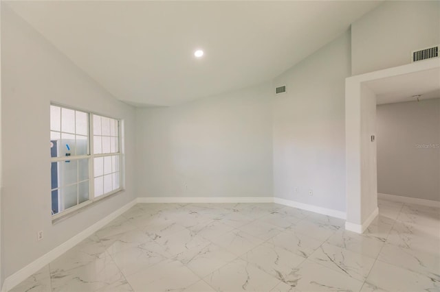 empty room featuring high vaulted ceiling