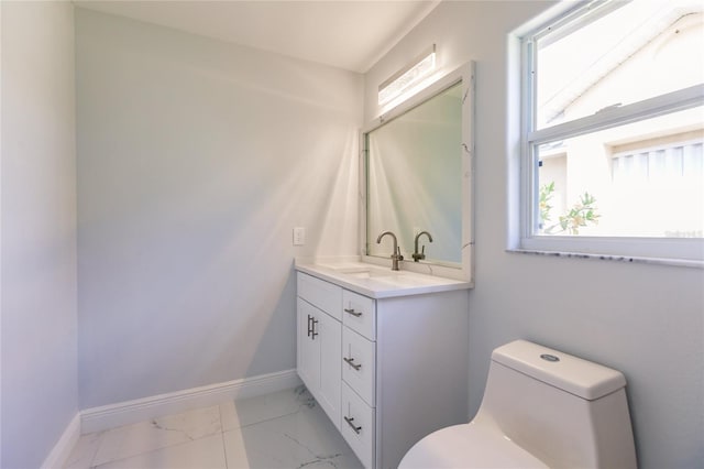 bathroom featuring vanity and toilet