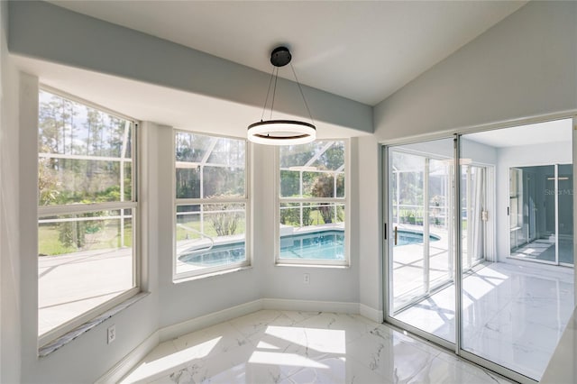 unfurnished dining area featuring vaulted ceiling