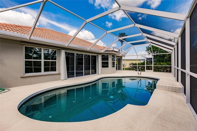 view of pool featuring a patio and glass enclosure