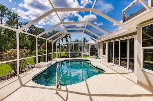 view of swimming pool featuring a lanai and a patio