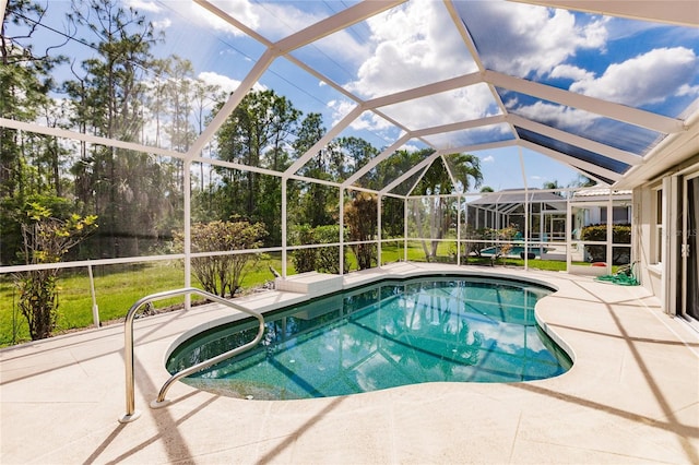 view of pool featuring a patio area and glass enclosure