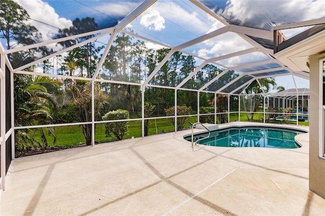 view of swimming pool featuring a lanai and a patio area