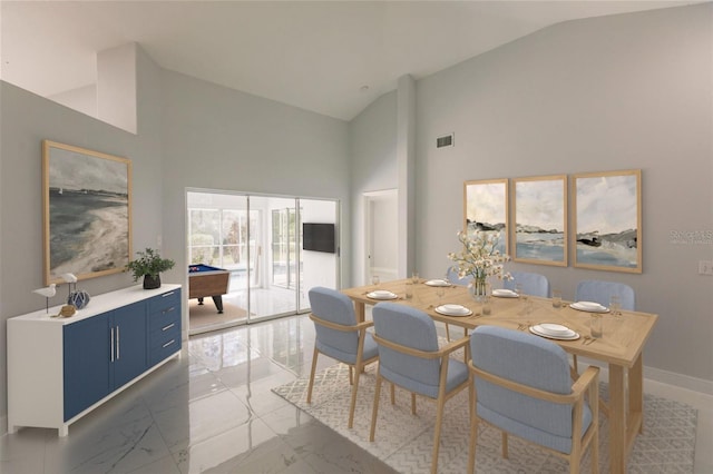 dining area featuring high vaulted ceiling