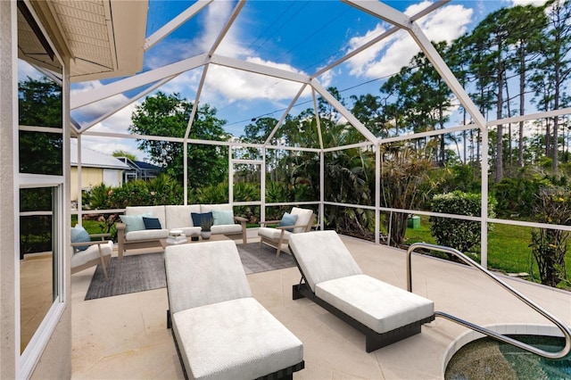 view of patio featuring outdoor lounge area and glass enclosure