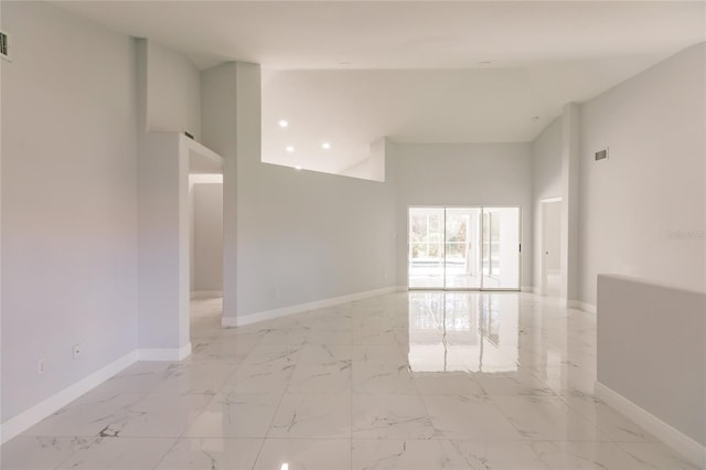 spare room featuring a high ceiling