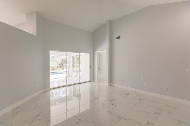 empty room featuring high vaulted ceiling