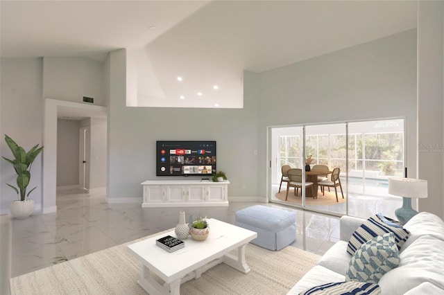 living room featuring a towering ceiling