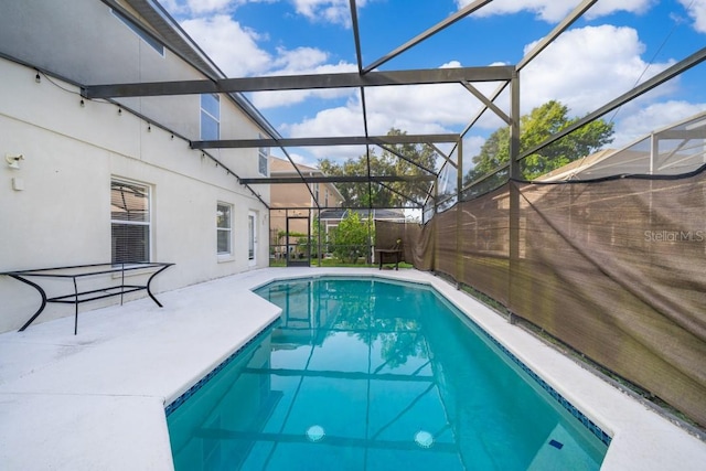 view of pool with a lanai and a patio