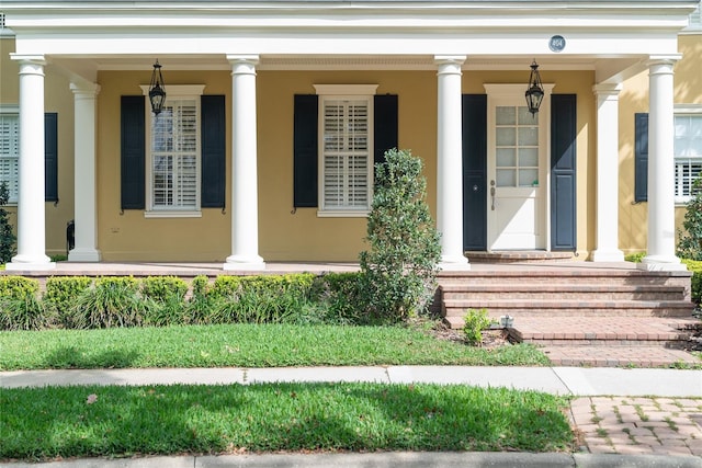 view of exterior entry with a porch