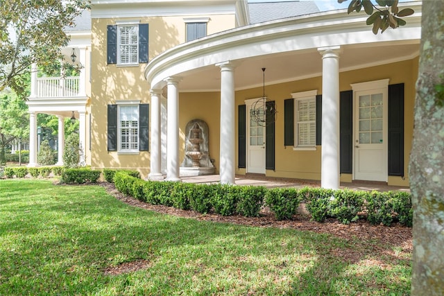 view of exterior entry featuring a yard