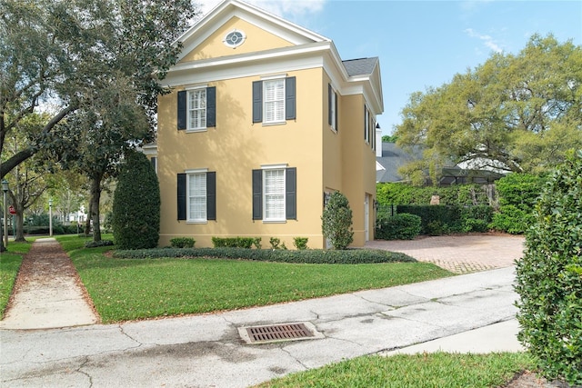 greek revival house with a front yard