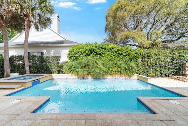 view of pool with an in ground hot tub and a patio