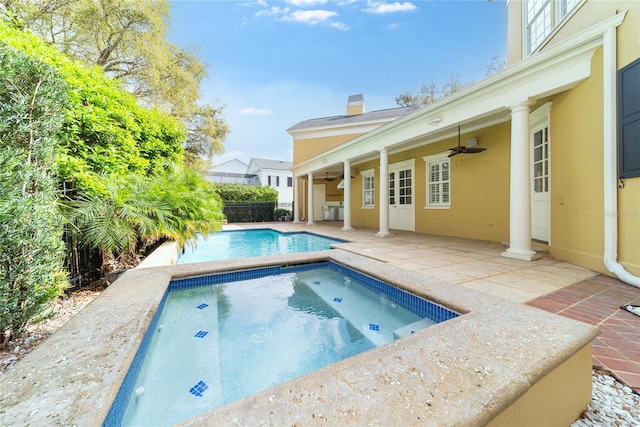 view of pool with ceiling fan and a patio