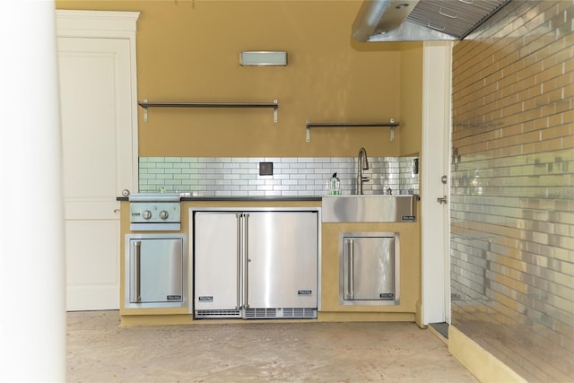 kitchen featuring premium range hood, fridge, and sink