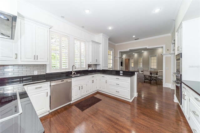 kitchen with white cabinets, appliances with stainless steel finishes, and dark hardwood / wood-style floors