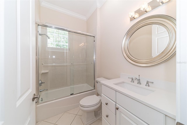 full bathroom featuring combined bath / shower with glass door, tile flooring, toilet, crown molding, and large vanity