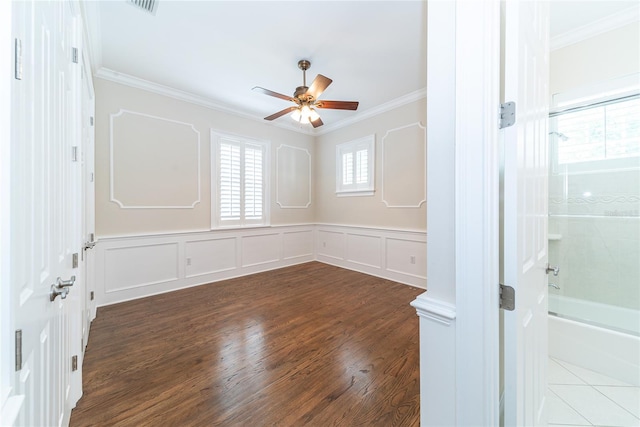 unfurnished room with ornamental molding, dark hardwood / wood-style flooring, and ceiling fan