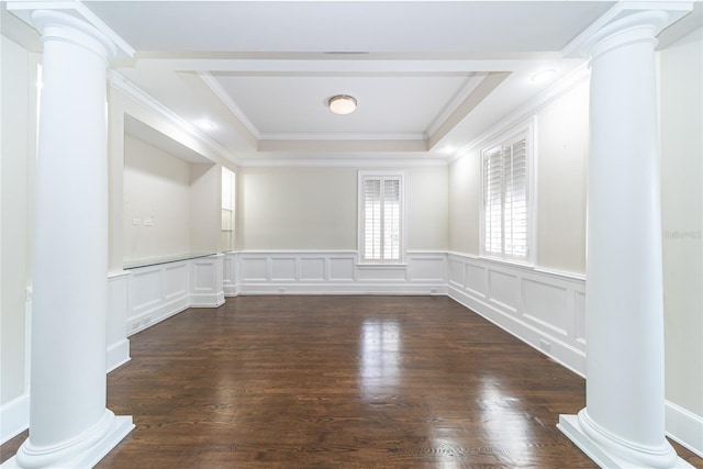 empty room featuring a raised ceiling, crown molding, ornate columns, and dark hardwood / wood-style flooring