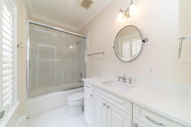 full bathroom with tile floors, oversized vanity, toilet, crown molding, and enclosed tub / shower combo