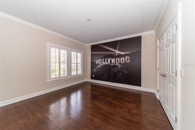 empty room with dark hardwood / wood-style flooring and ornamental molding